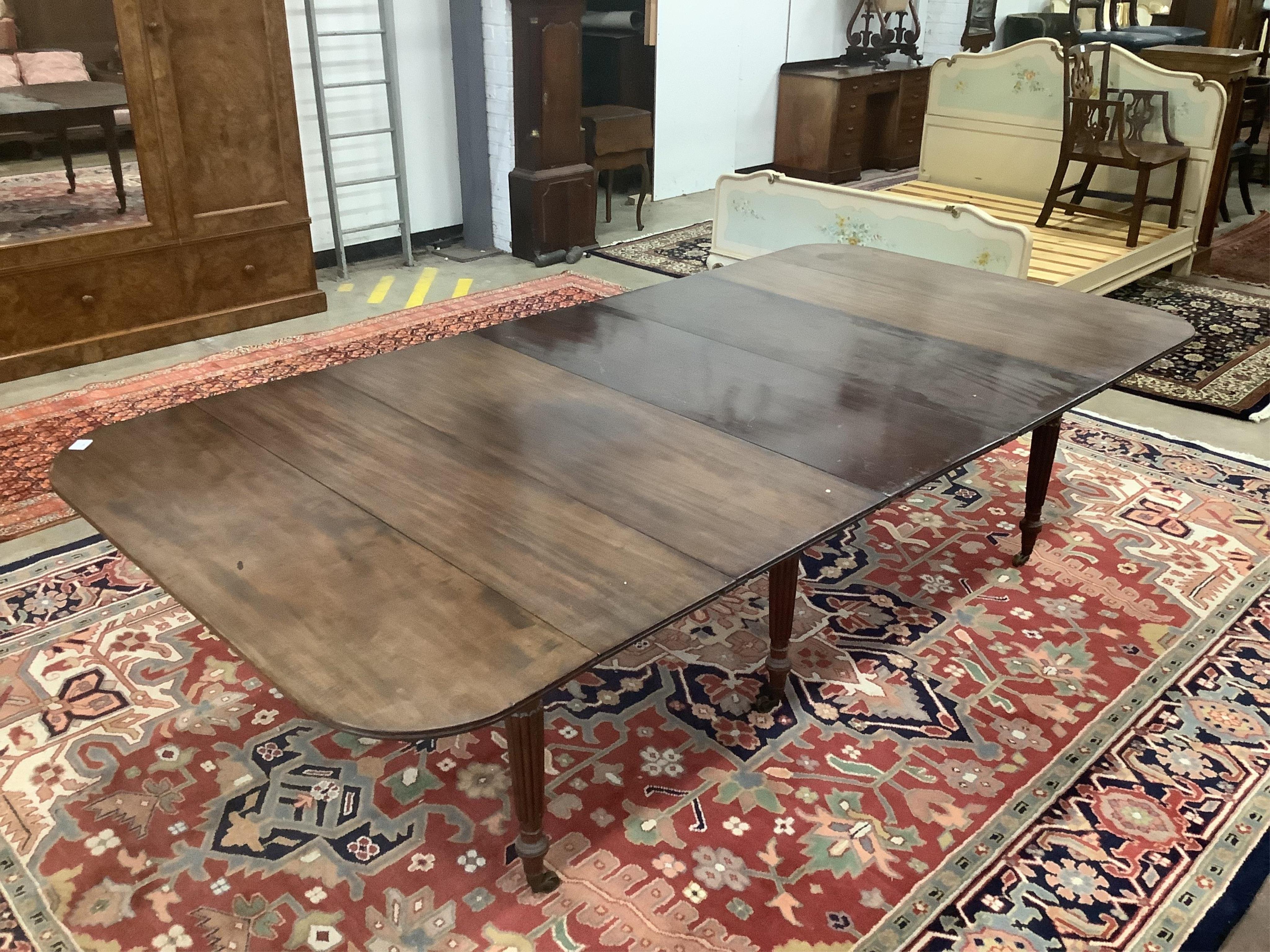 A Regency Gillows style mahogany extending dining table, 276cm extended, three spare leaves, depth 137cm, height 71cm. Condition - fair